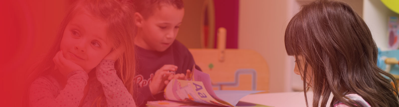 kids sitting at a daycare table doing crafts