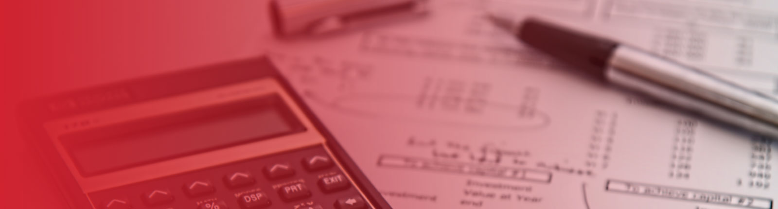 calculator beside financial reports with pen